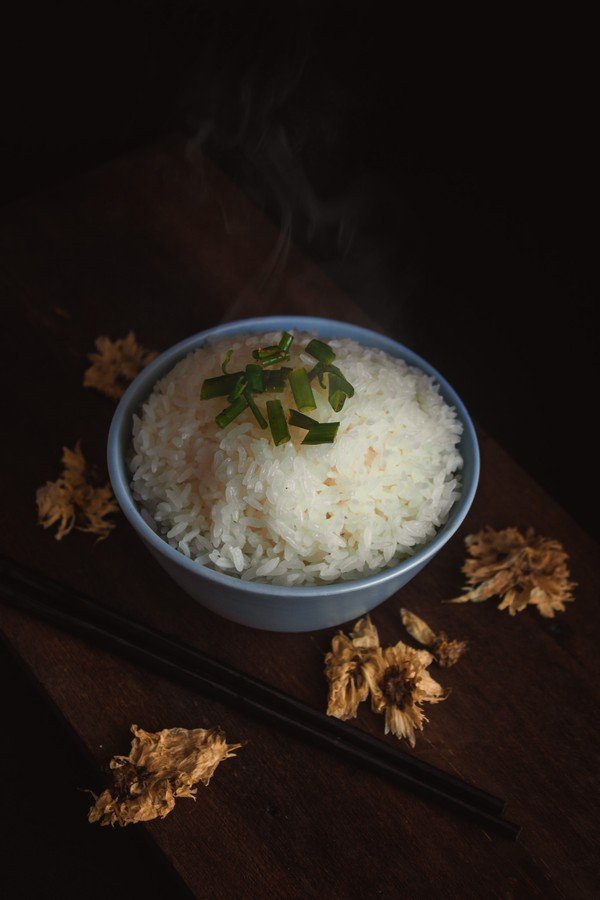 Steaming bowl of Instant Pot white rice garnished with scallions